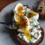 Creamy herbed Greek yogurt served with smashed eggs for a flavorful breakfast dish