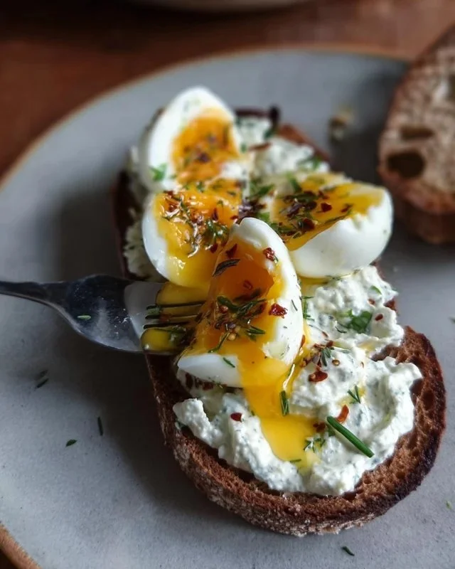 Creamy herbed Greek yogurt served with smashed eggs for a flavorful breakfast dish