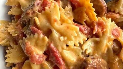 Creamy Cajun sausage pasta in a bowl garnished with herbs