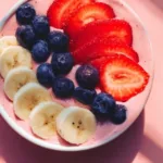 Colorful fruit smoothie bowl topped with fresh berries and granola.