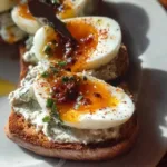 Creamy herbed yogurt served with soft-cooked eggs in a bowl